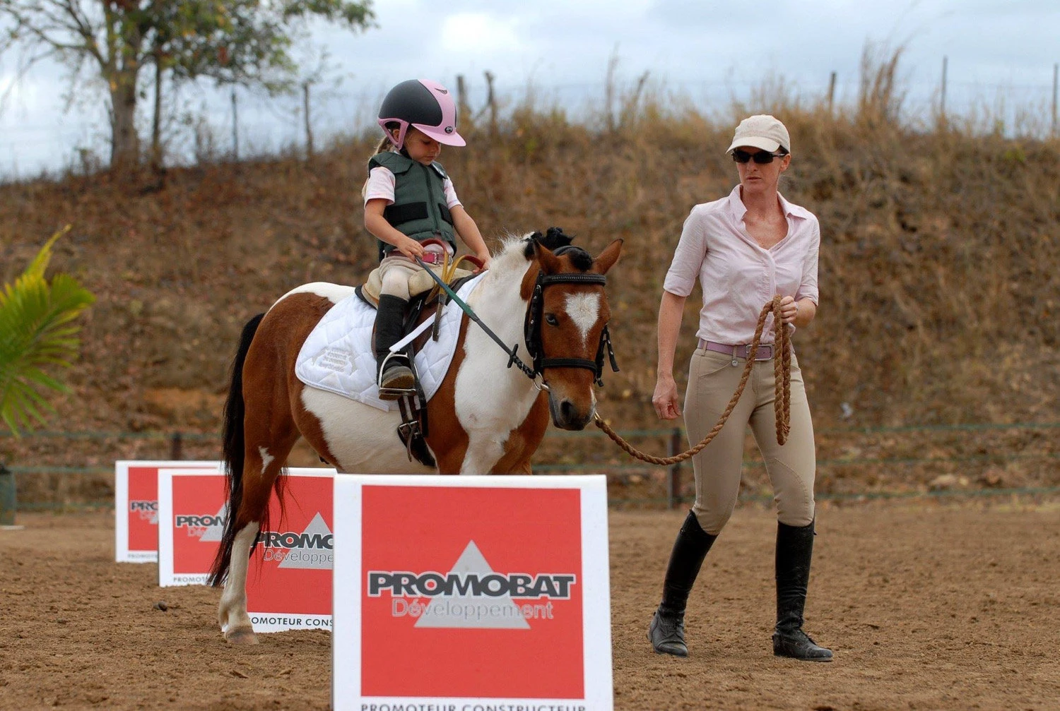 A young rider and coach at a competition