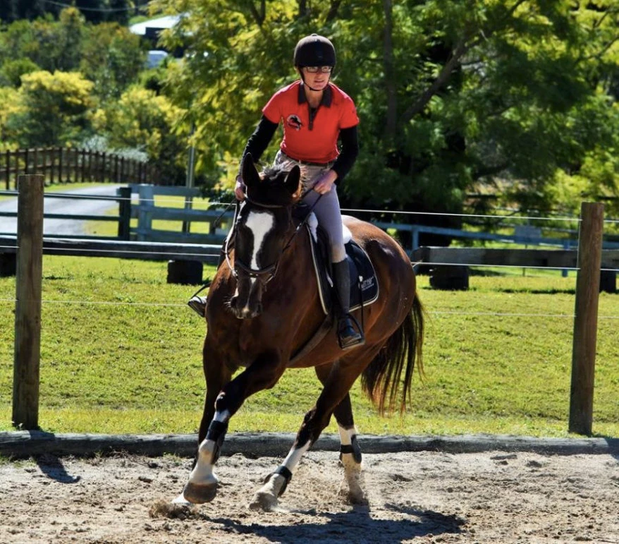 A coach with a young rider on a pony