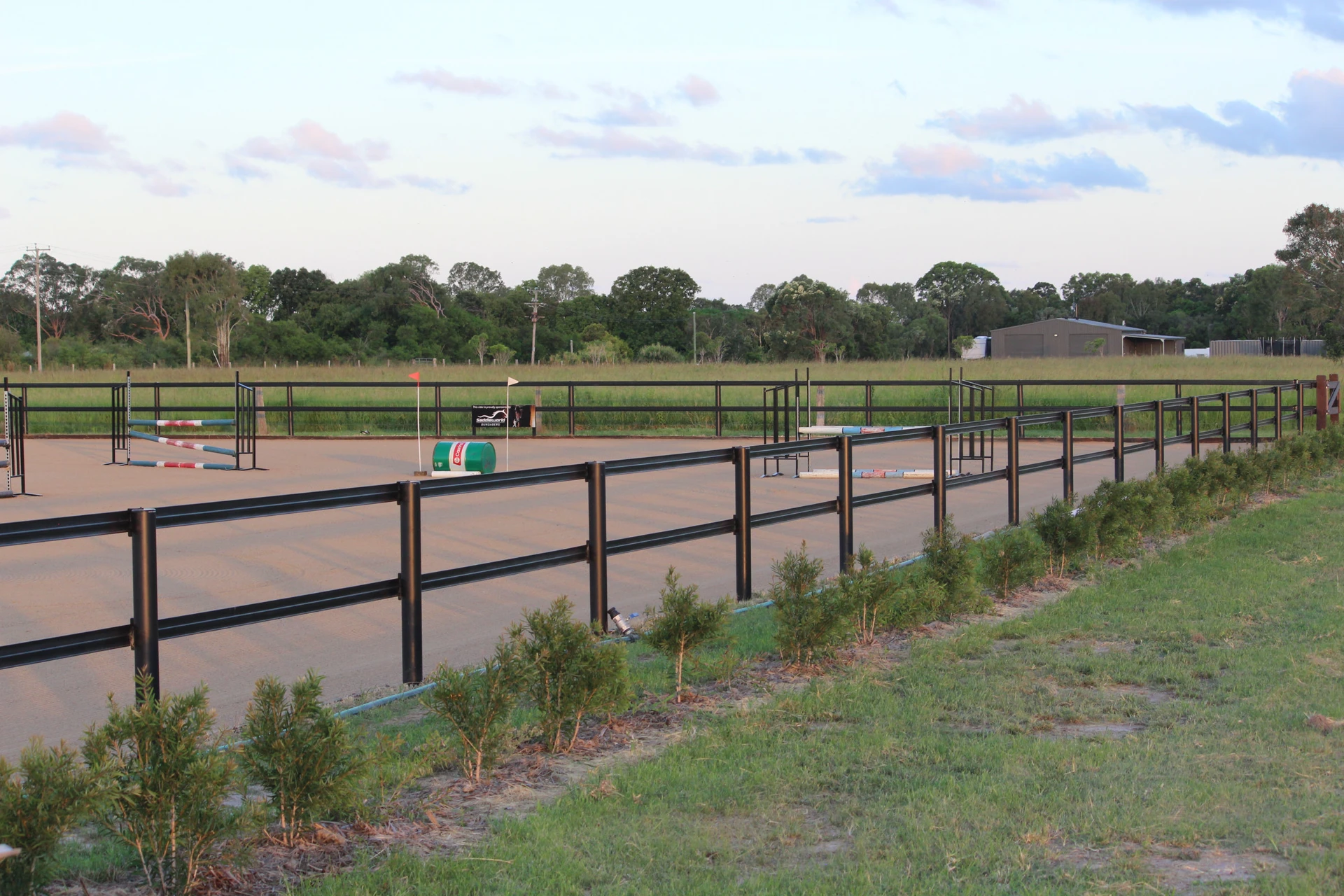 The fenced sand arena and garden beds