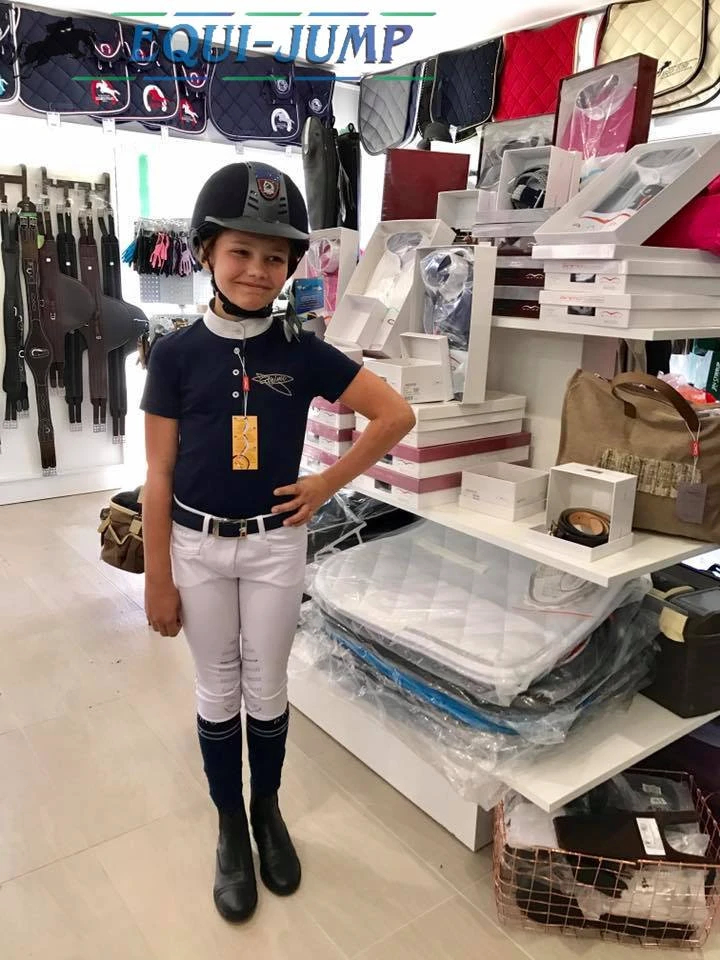 A young rider trying on riding gear in the boutique